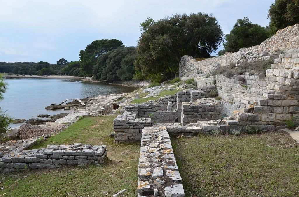 Ruins of an ancient Roman villa sit along the shore of Verige Bay in Brijuni National Park, Croatia.